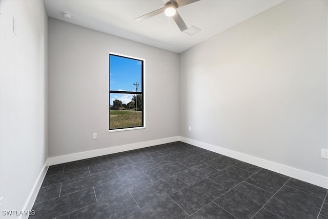 tiled spare room with ceiling fan