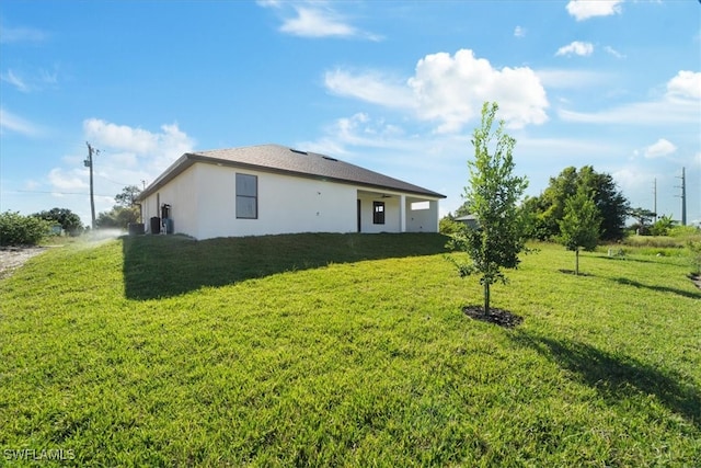 view of side of home with a lawn