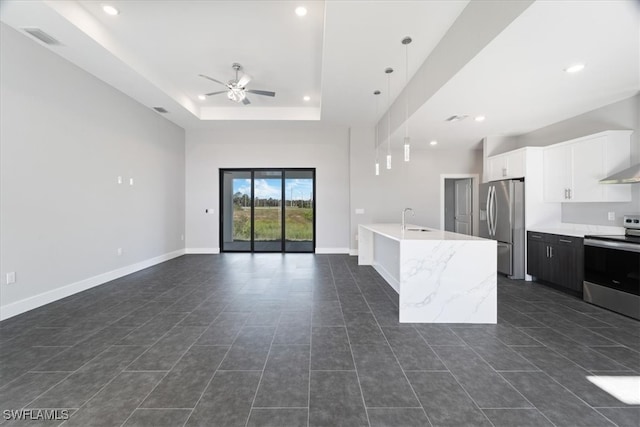 kitchen featuring appliances with stainless steel finishes, sink, ceiling fan, pendant lighting, and white cabinets