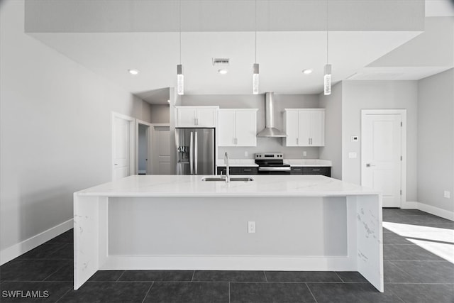 kitchen with a large island with sink, wall chimney range hood, sink, white cabinetry, and stainless steel appliances