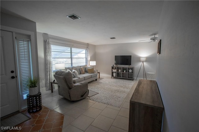 tiled living room with ceiling fan