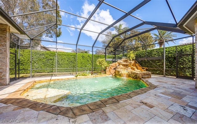 view of swimming pool featuring a patio, pool water feature, and glass enclosure