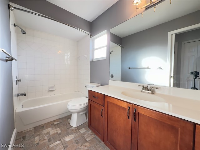 full bathroom with vanity, toilet, and tiled shower / bath