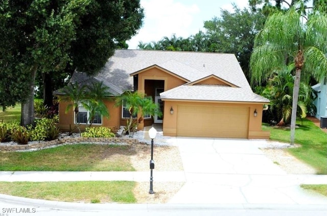 view of front facade featuring a front lawn and a garage