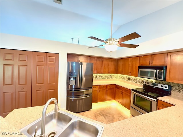 kitchen with tasteful backsplash, vaulted ceiling, light hardwood / wood-style flooring, sink, and stainless steel appliances