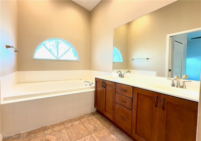 bathroom featuring vanity and tiled tub