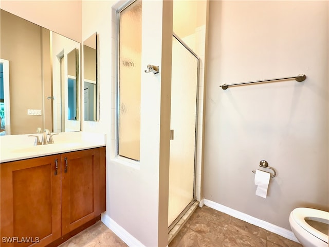 bathroom featuring a shower with door, toilet, and vanity