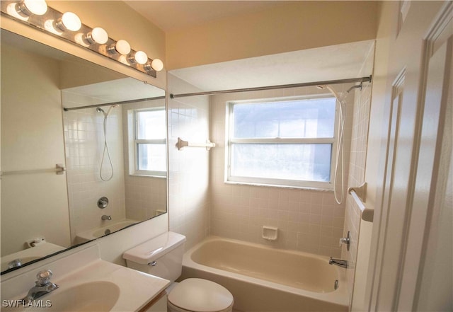 full bathroom featuring toilet, tiled shower / bath combo, and vanity