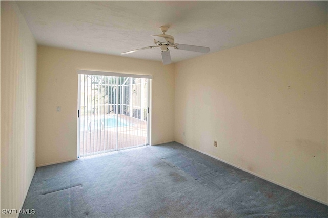 carpeted spare room featuring ceiling fan