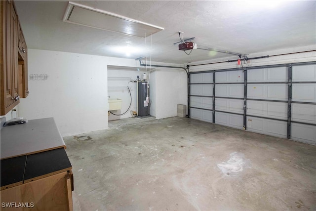 garage with a garage door opener, sink, and water heater