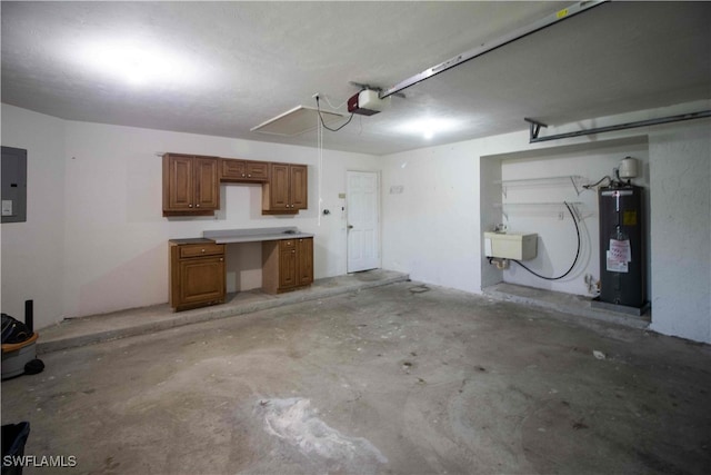 garage featuring a garage door opener, electric water heater, electric panel, and sink