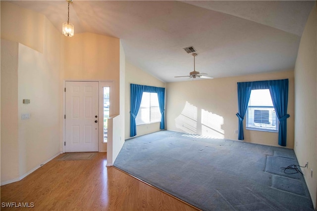 foyer entrance featuring ceiling fan, lofted ceiling, and hardwood / wood-style floors