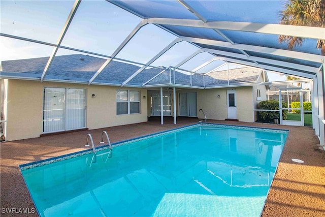 view of swimming pool featuring a patio area and a lanai