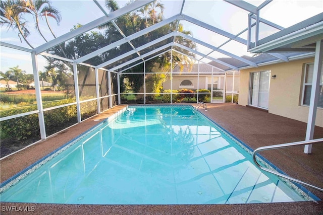 view of swimming pool with a patio area and glass enclosure