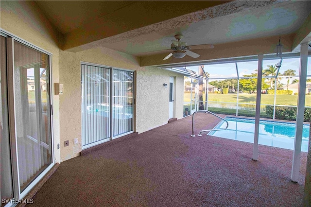 view of swimming pool featuring a lanai, a patio, and ceiling fan