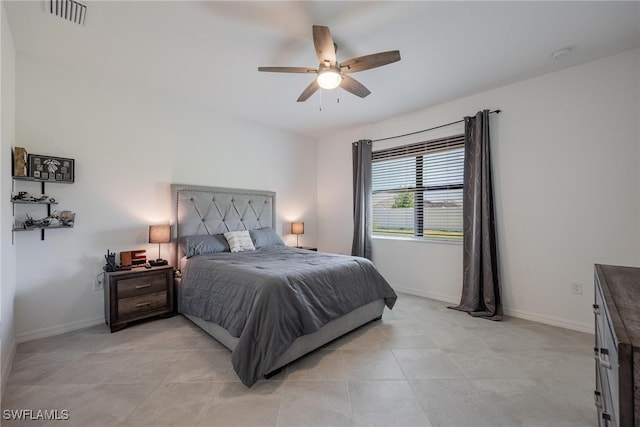 tiled bedroom featuring ceiling fan