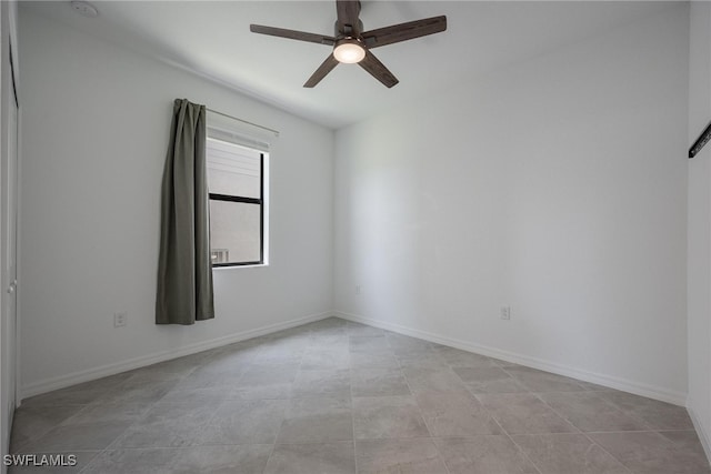 empty room with light tile patterned floors and ceiling fan