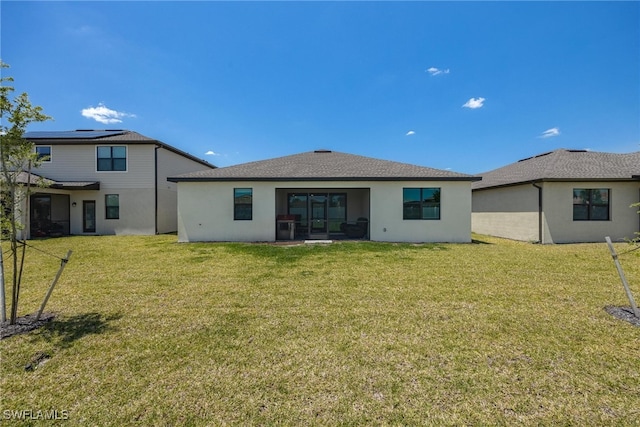 back of house with a patio and a lawn