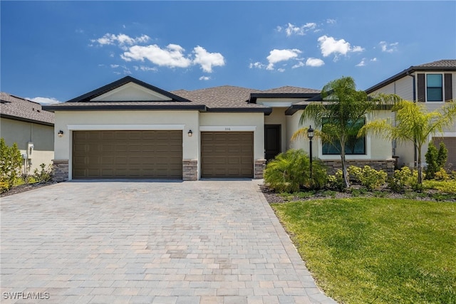 view of front of property featuring a front yard and a garage