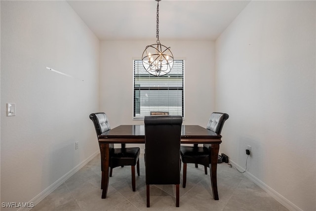 tiled dining room featuring a chandelier