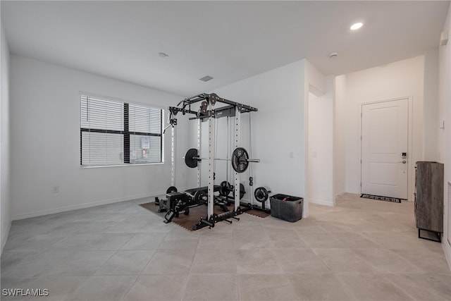 exercise room with light tile patterned flooring