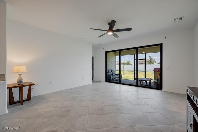 tiled empty room with ceiling fan