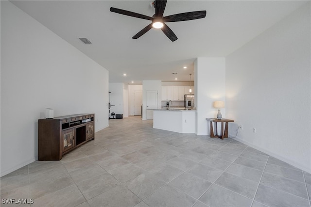 unfurnished living room with light tile patterned floors and ceiling fan