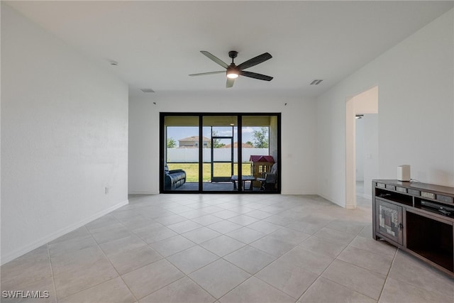 empty room with light tile patterned floors and ceiling fan