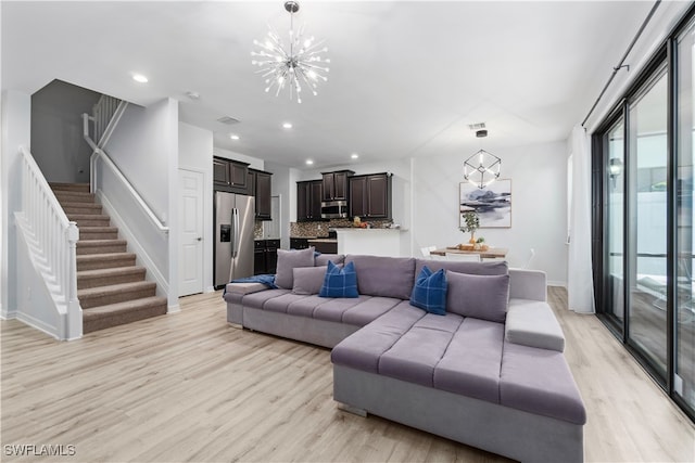 living room featuring a chandelier and light hardwood / wood-style floors