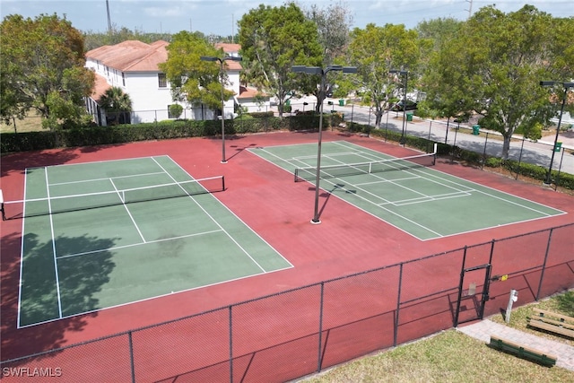 view of tennis court with basketball hoop