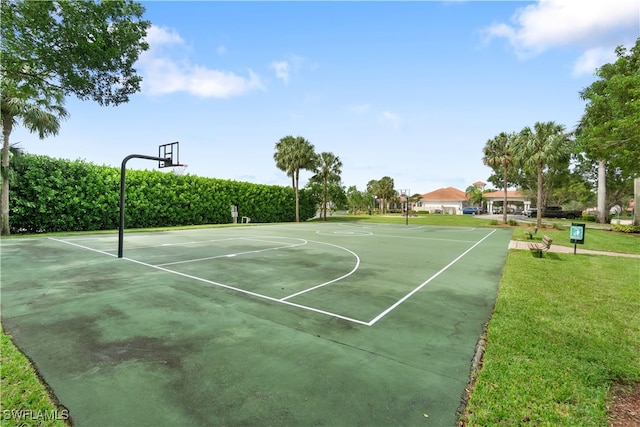 view of sport court featuring a yard