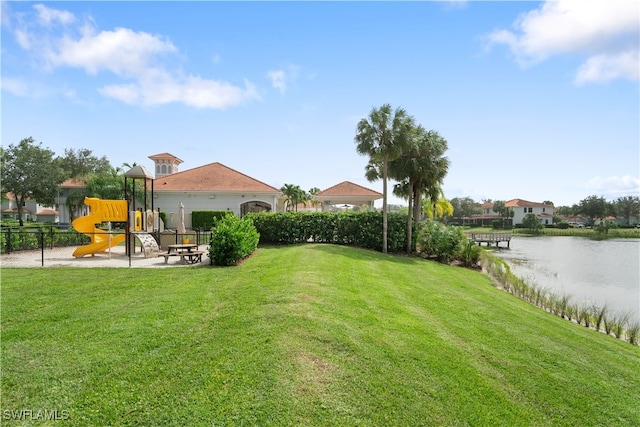 view of yard with a playground and a water view