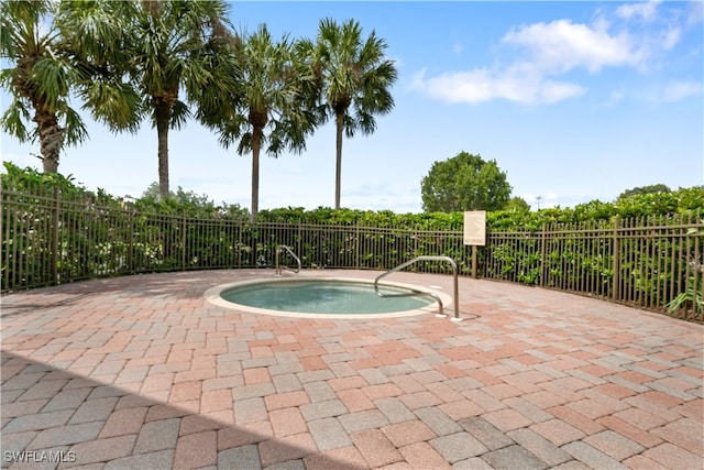 view of pool featuring a patio and an in ground hot tub