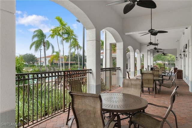 view of patio with a balcony and ceiling fan