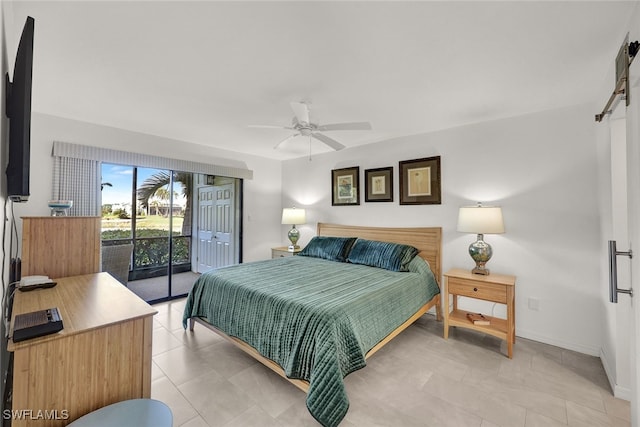 bedroom featuring a barn door, access to exterior, light tile patterned flooring, and ceiling fan