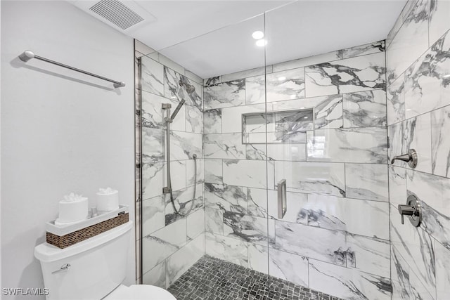 full bathroom with toilet, a stall shower, and visible vents