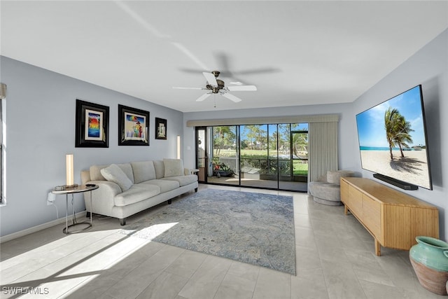 living room featuring ceiling fan and baseboards