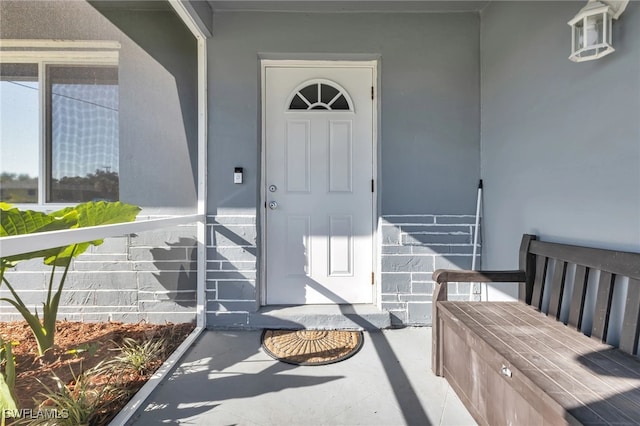 view of exterior entry featuring a porch