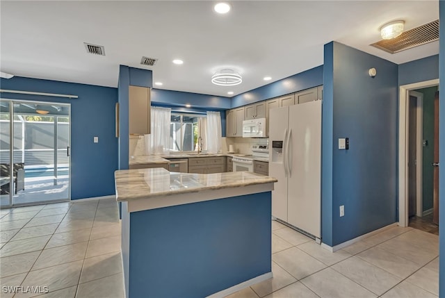 kitchen featuring sink, white appliances, a healthy amount of sunlight, and backsplash