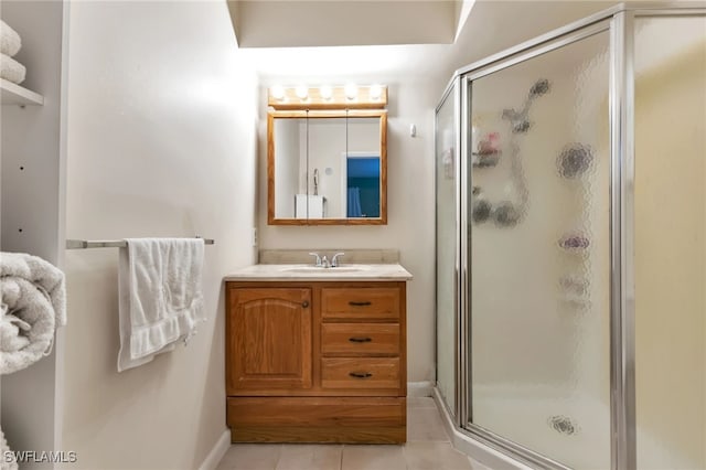 bathroom with tile patterned floors, vanity, and walk in shower