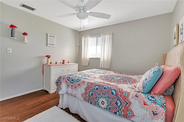 bedroom with ceiling fan and dark hardwood / wood-style flooring