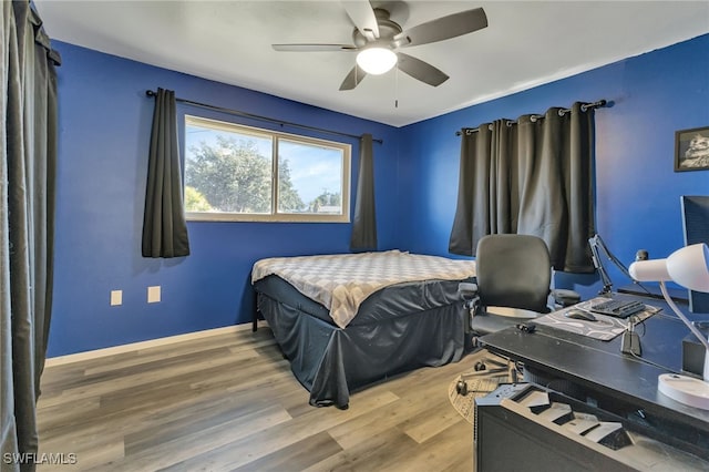 bedroom with ceiling fan and hardwood / wood-style flooring