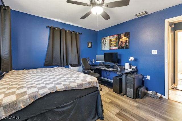 bedroom with ceiling fan and light wood-type flooring