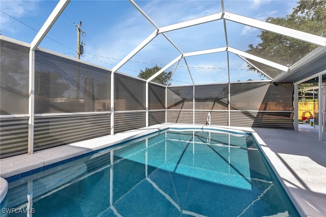 view of swimming pool with glass enclosure