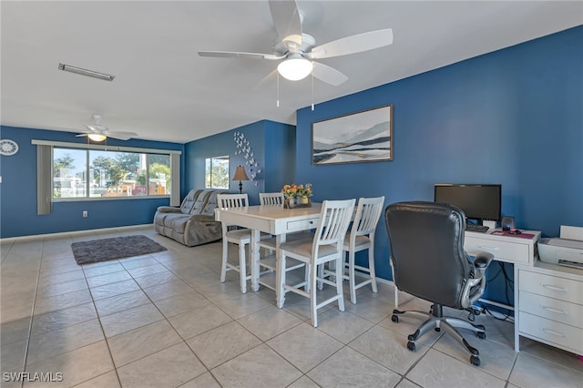 tiled dining area with ceiling fan