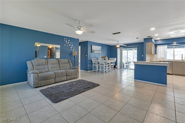 living room with ceiling fan and light tile patterned floors