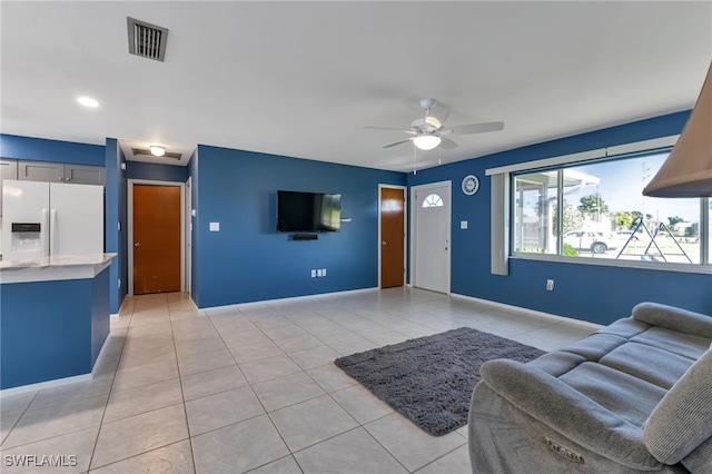 tiled living room with ceiling fan