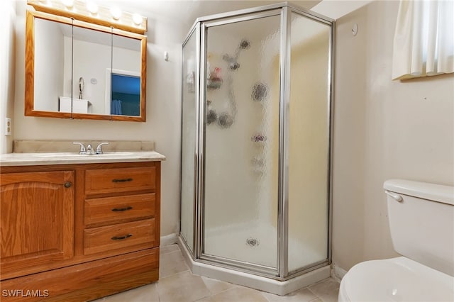 bathroom featuring tile patterned flooring, vanity, toilet, and an enclosed shower