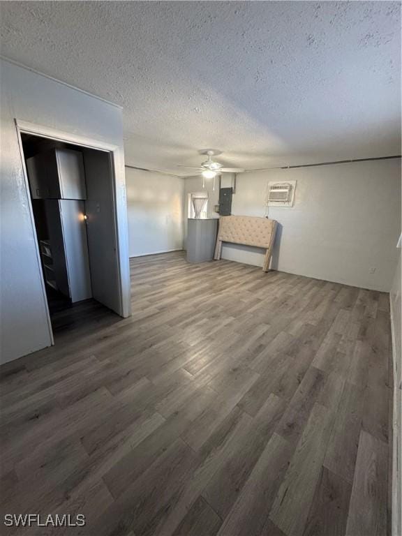 interior space with ceiling fan, dark hardwood / wood-style floors, and a textured ceiling