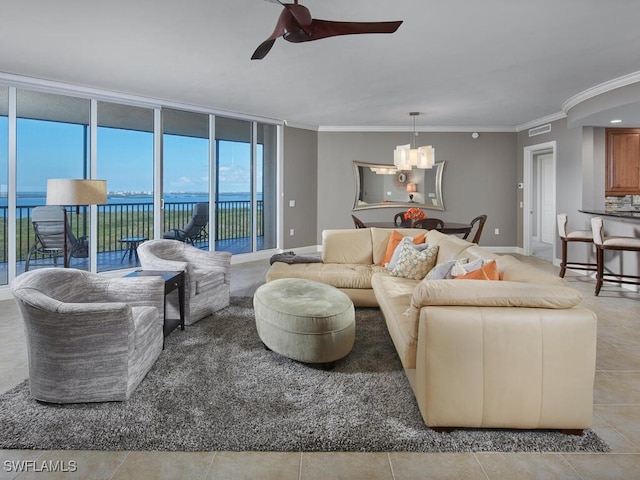 living room with crown molding, light tile patterned floors, a water view, ceiling fan with notable chandelier, and floor to ceiling windows